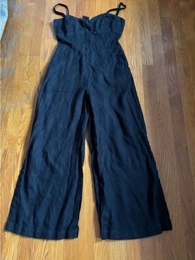 Reformation black linen jumpsuit with front tie and pockets